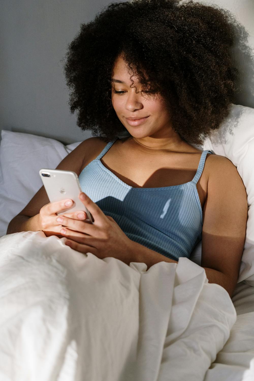 Woman smiling while using Faye period tracker app